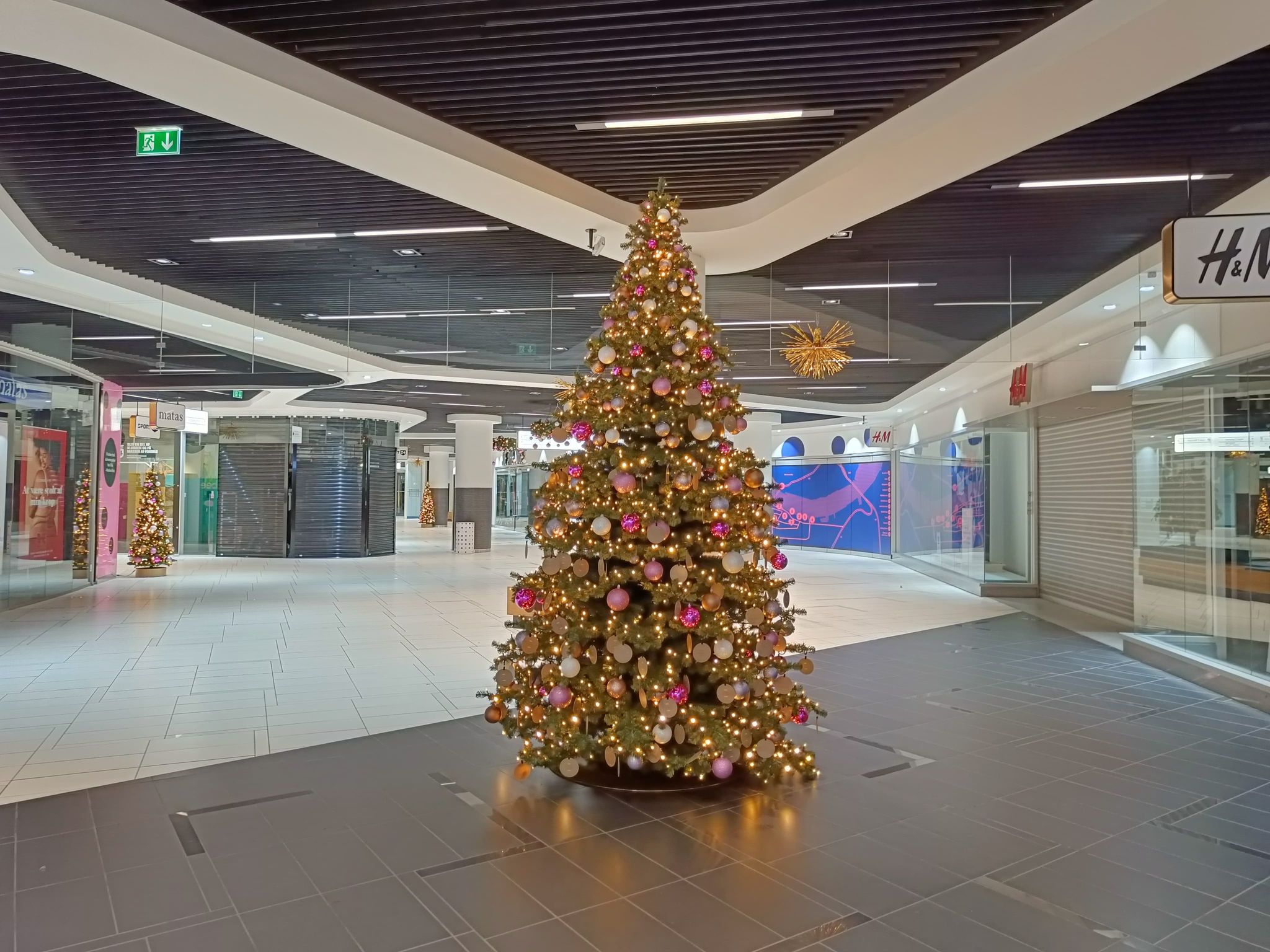 Kunstigt juletræ med julekugler og lyskæder